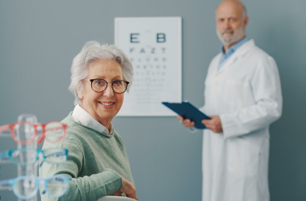 An optometrist tests a senior woman's eyesight with the an eye chart.
