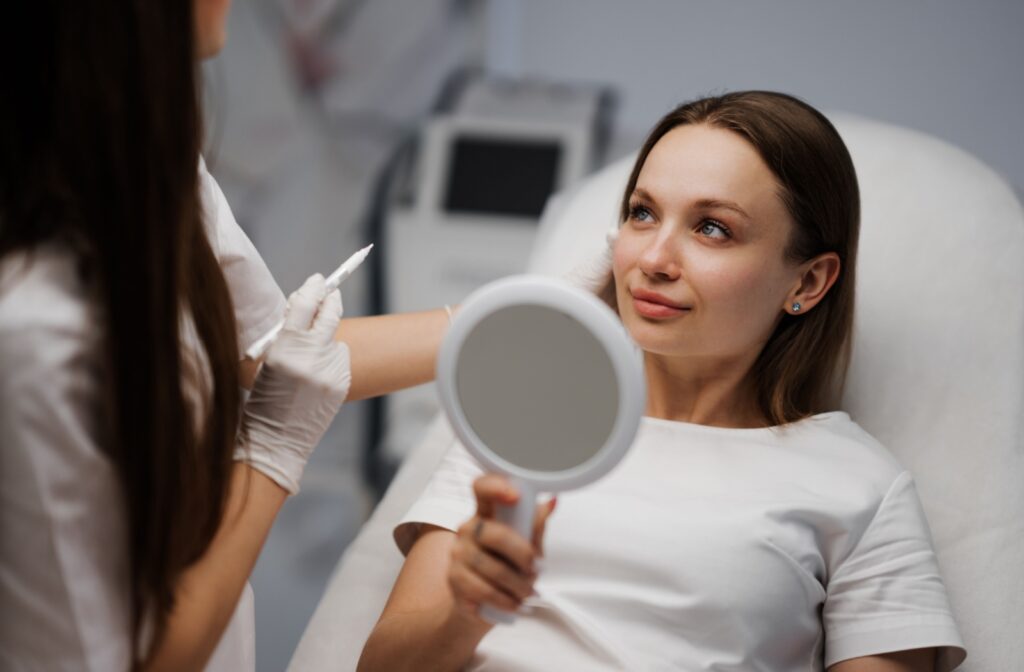 A young woman discusses the details of her photofacial treatment with her optometrist during her initial consultation.