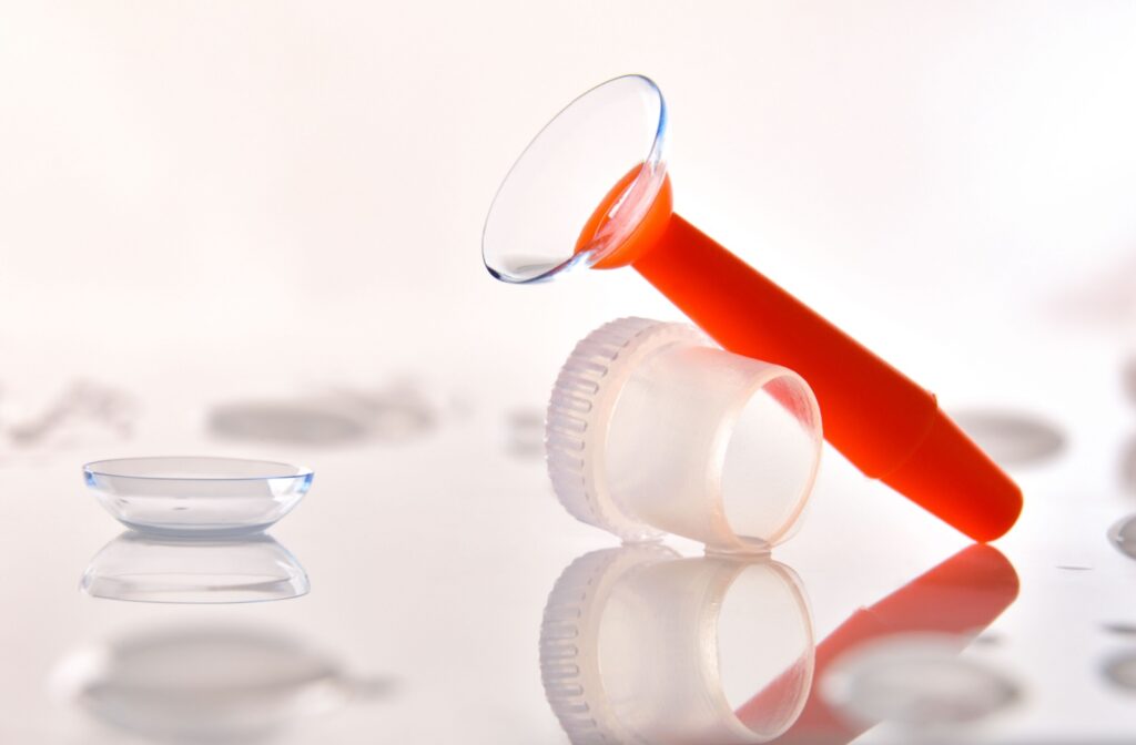 A closeup of a scleral lens being held by an applicator.