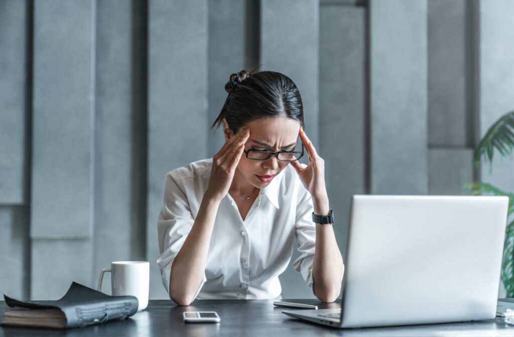 A person massaging their temples to help alleviate headache symptoms from eye strain.