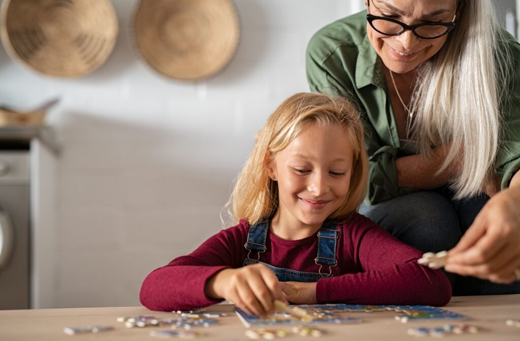 A child and an adult work on a puzzle together fostering visual memory skills