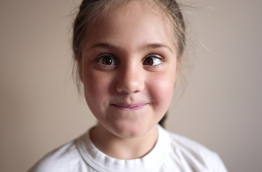 Young child looking into the camera with one eye turned inwards