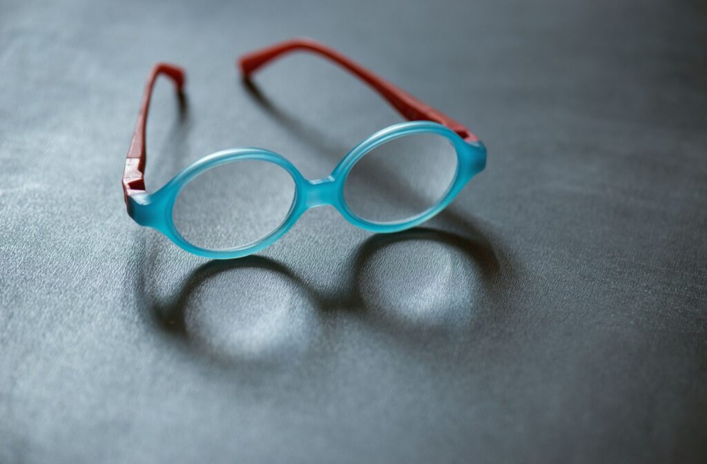 a pair of children's blue glasses with red arms
