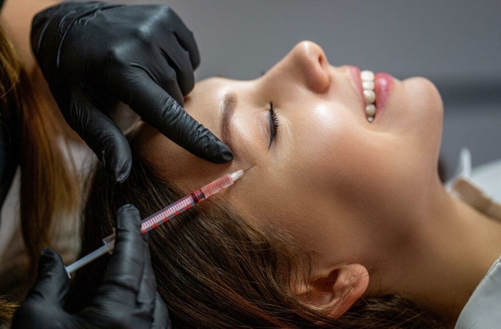 A person getting botox right near their eye to help